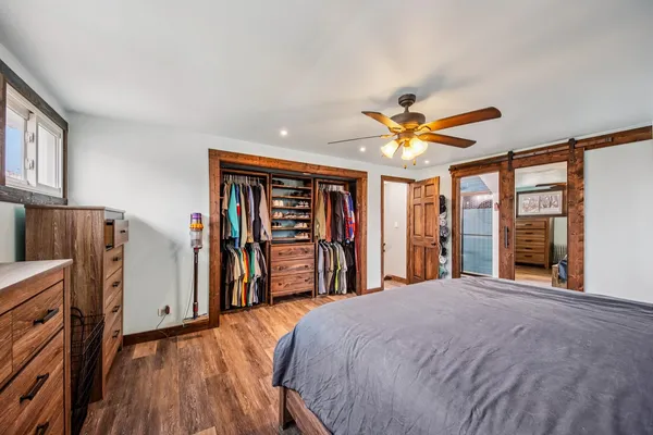 a view of a livingroom with a furniture hardwood floor and a ceiling fan