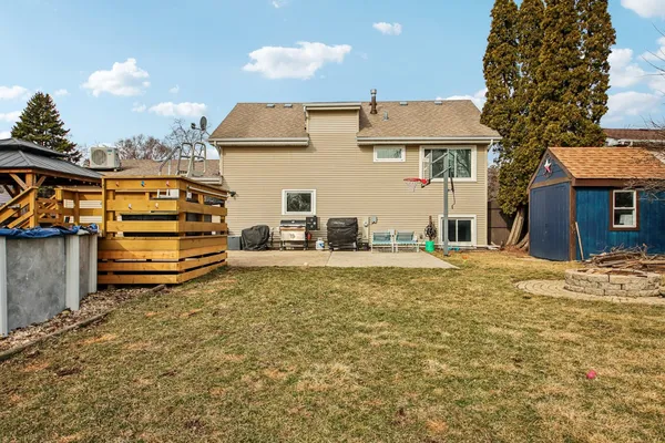 a view of a house with a backyard and a tree