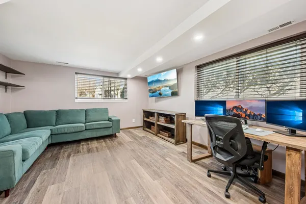 a living room with furniture and a wooden floor