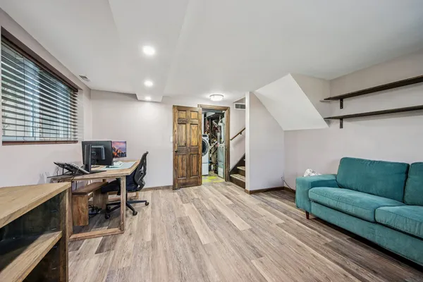 a workspace with furniture and wooden floor