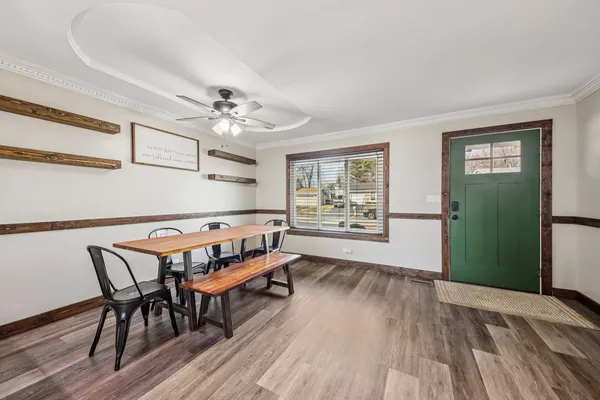 a view of a dining room with furniture window and wooden floor