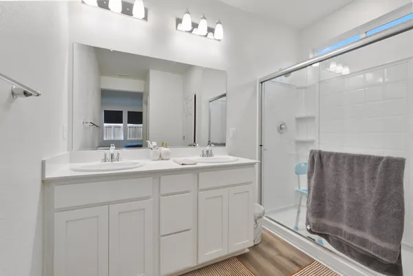 a bathroom with a double vanity sink and mirror