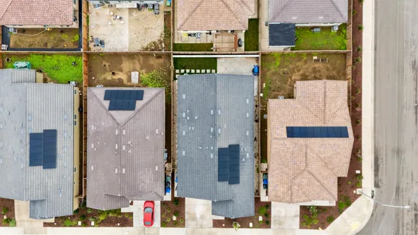 an aerial view of residential houses with outdoor space and swimming pool