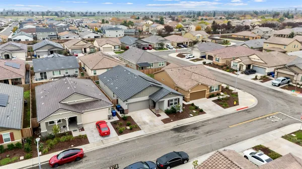 an aerial view of residential houses with outdoor space