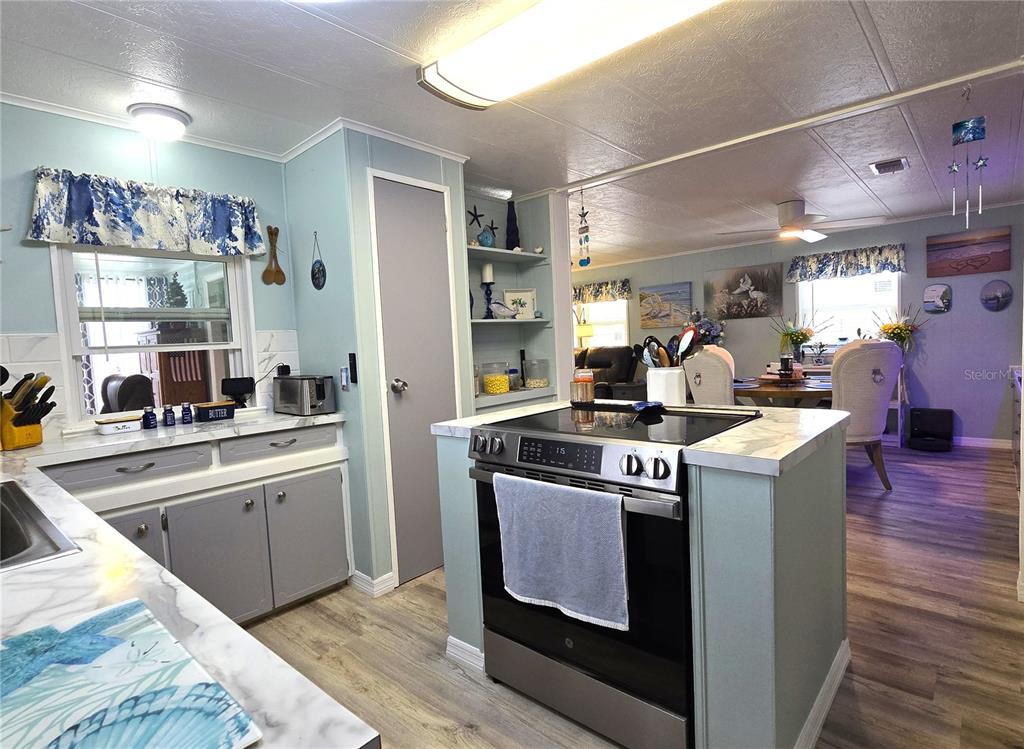 5619 Bayshore Road, Unit 435 Palmetto, FL 34221 - Photo 14 of 56 a kitchen with a stove and wooden floor