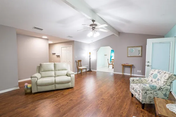 a living room with furniture and a chandelier