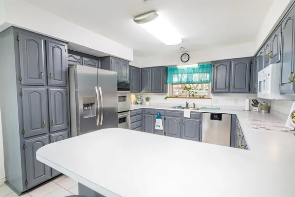 a kitchen with stainless steel appliances granite countertop a refrigerator sink and cabinets