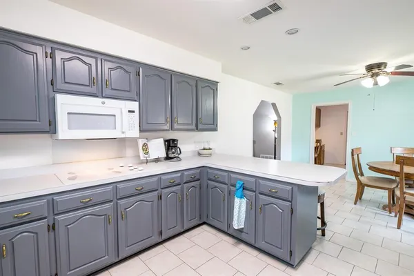 a kitchen with a sink cabinets and window