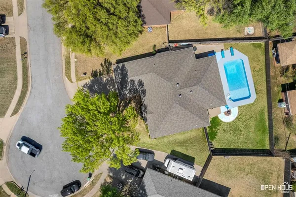 an aerial view of a house with a yard basket ball court