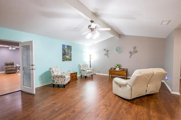 a living room with furniture and wooden floor