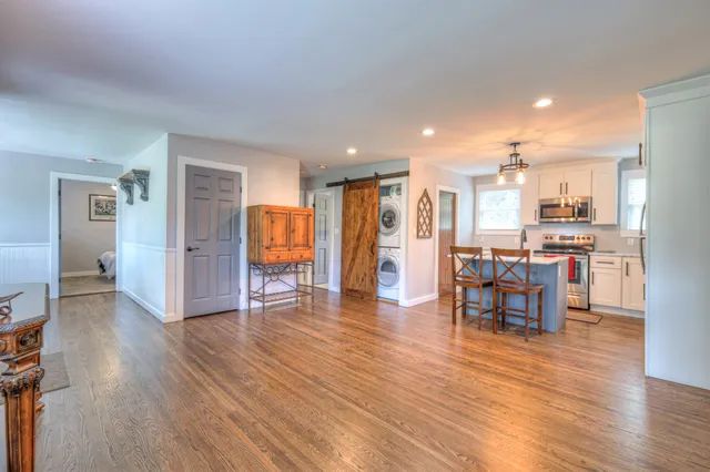 a view of dining room with furniture and wooden floor
