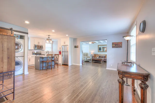a living room with lots of furniture and kitchen view