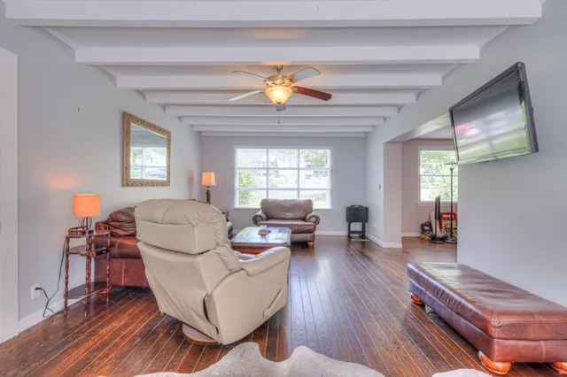 a living room with furniture and a wooden floor