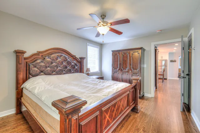 a bedroom with a bed and a chandelier