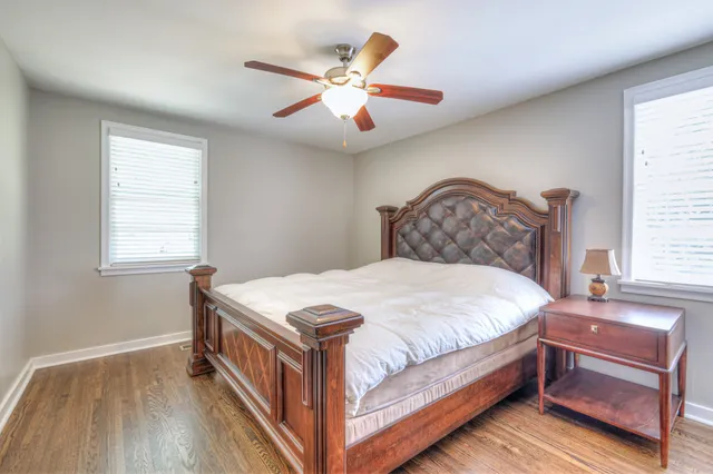 a bedroom with a large bed and a chandelier