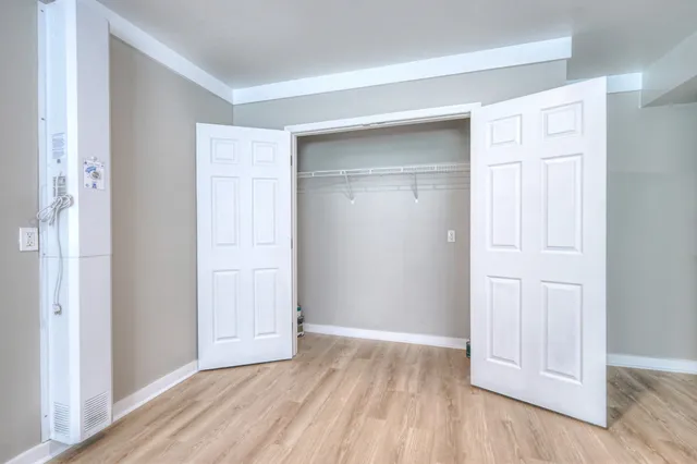 a view of an empty room with wooden floor