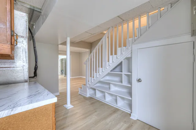 a view of entryway and hall with wooden floor