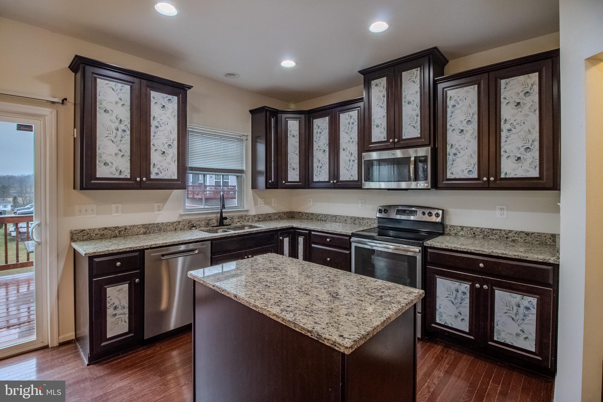 57 Tollerton Trail Falling Waters, WV 25419 - Photo 15 of 59 a kitchen with stainless steel appliances granite countertop a stove a sink and a microwave