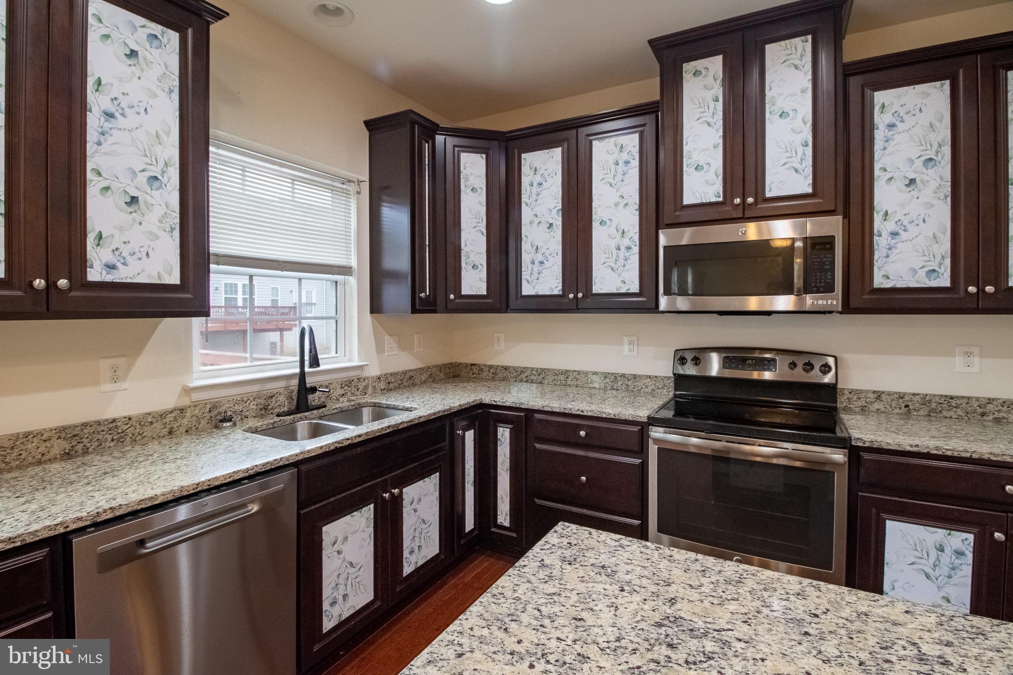 57 Tollerton Trail Falling Waters, WV 25419 - Photo 16 of 59 a kitchen with stainless steel appliances granite countertop a stove a sink and a microwave