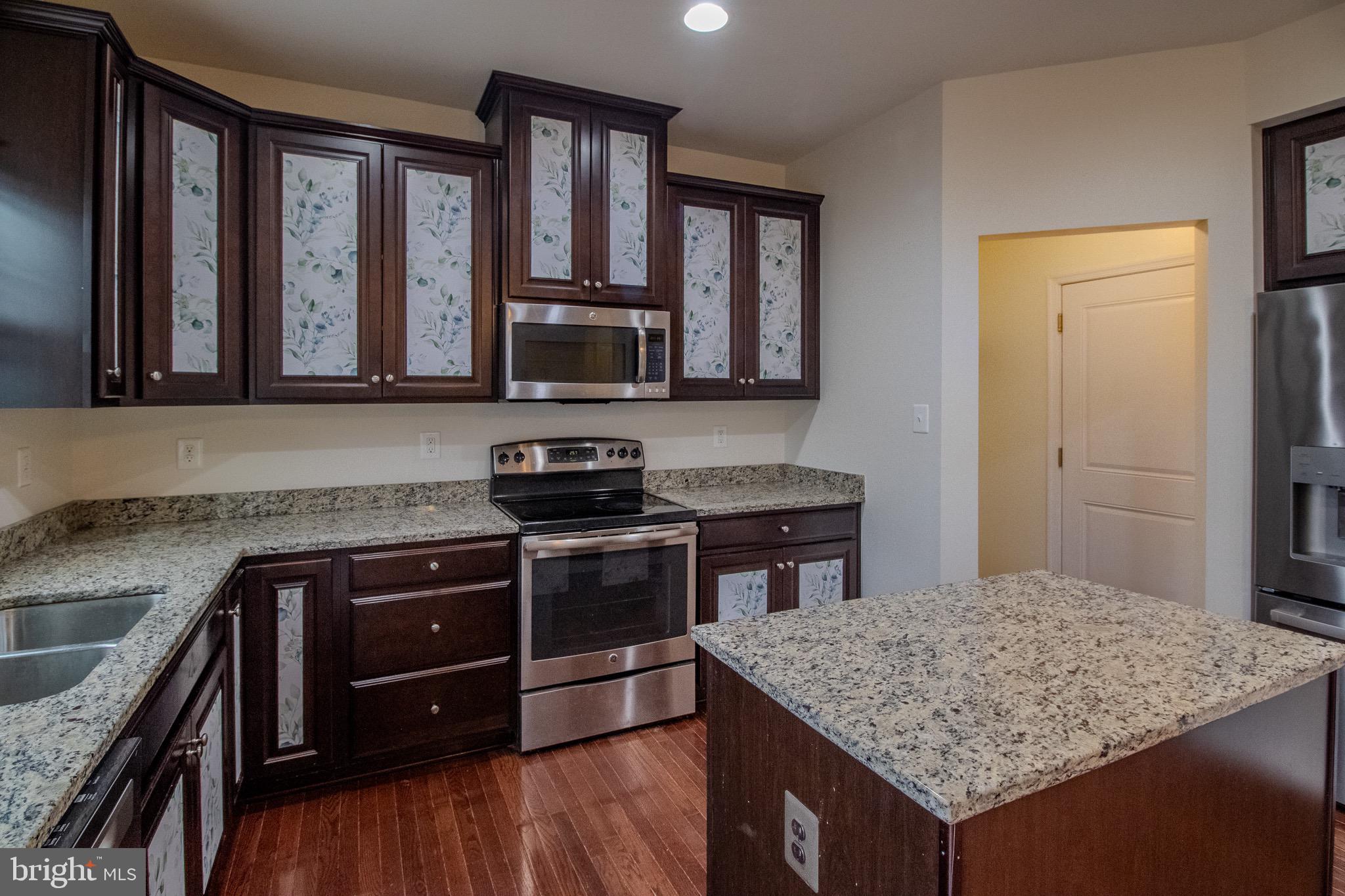 57 Tollerton Trail Falling Waters, WV 25419 - Photo 17 of 59 a kitchen with a stove a sink and a microwave