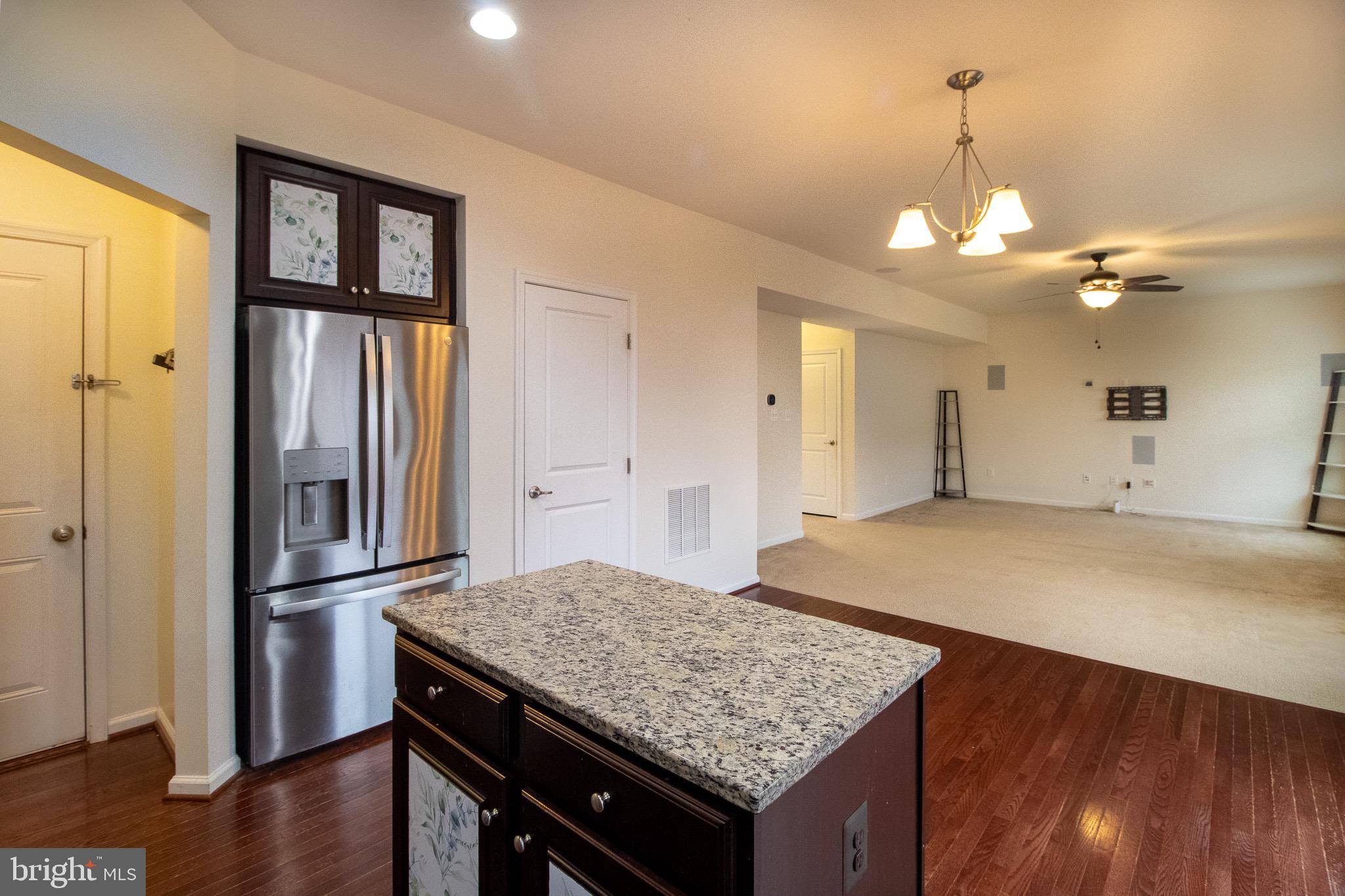 57 Tollerton Trail Falling Waters, WV 25419 - Photo 18 of 59 a kitchen with stainless steel appliances granite countertop a refrigerator a sink dishwasher a stove and white cabinets with wooden floor
