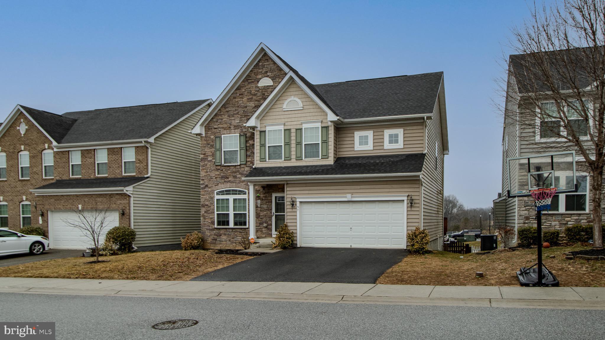 57 Tollerton Trail Falling Waters, WV 25419 - Photo 3 of 59 a front view of a house with a yard and garage