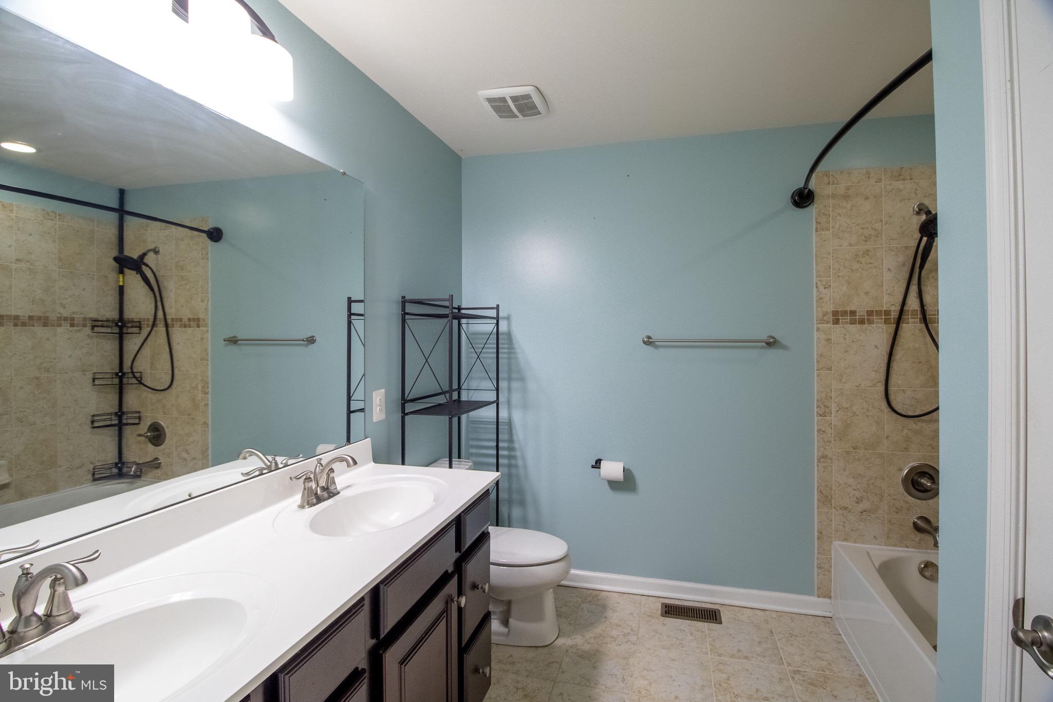 57 Tollerton Trail Falling Waters, WV 25419 - Photo 31 of 59 a bathroom with a granite countertop sink a toilet and shower
