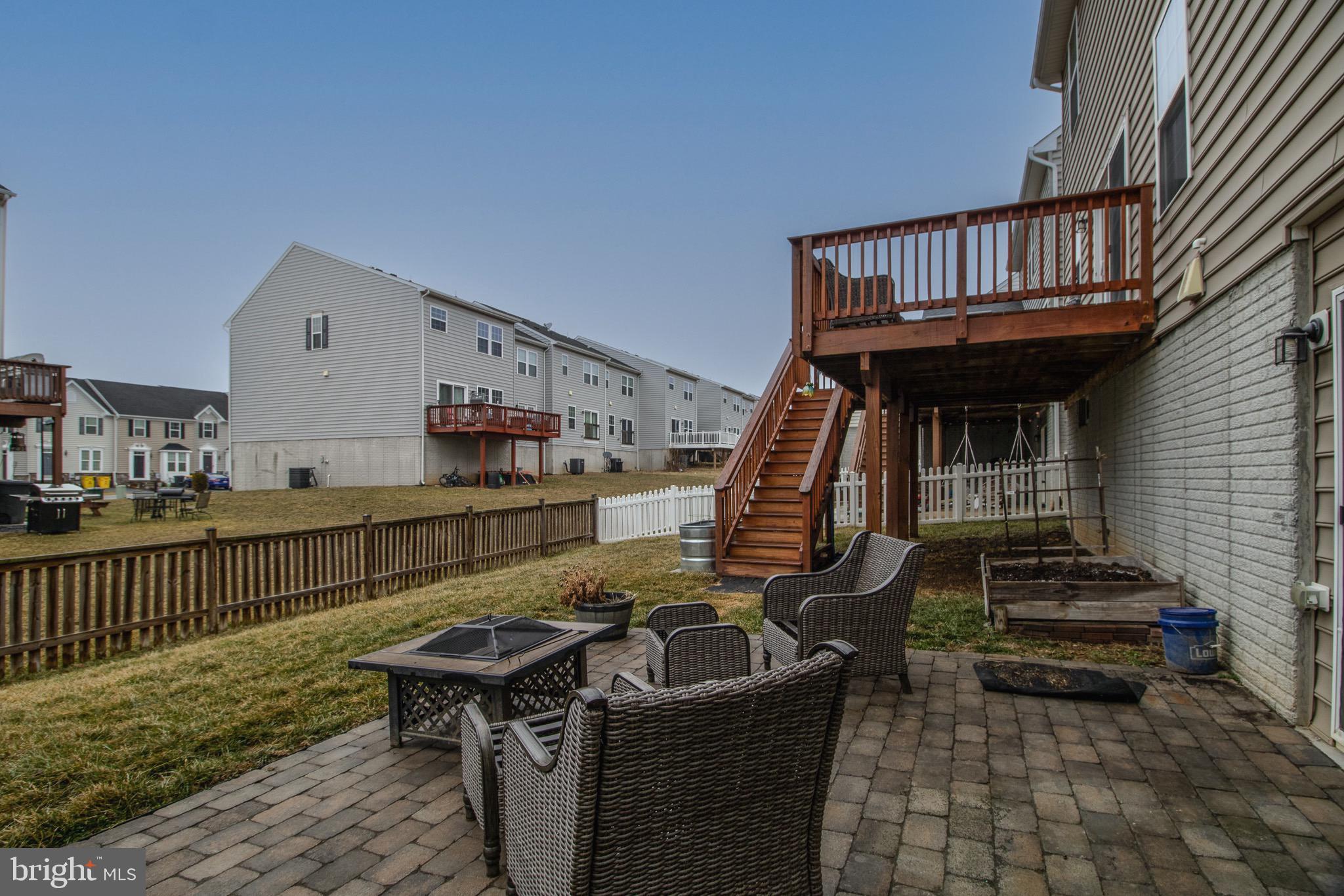 57 Tollerton Trail Falling Waters, WV 25419 - Photo 56 of 59 a view of a deck with couches chairs and wooden floor