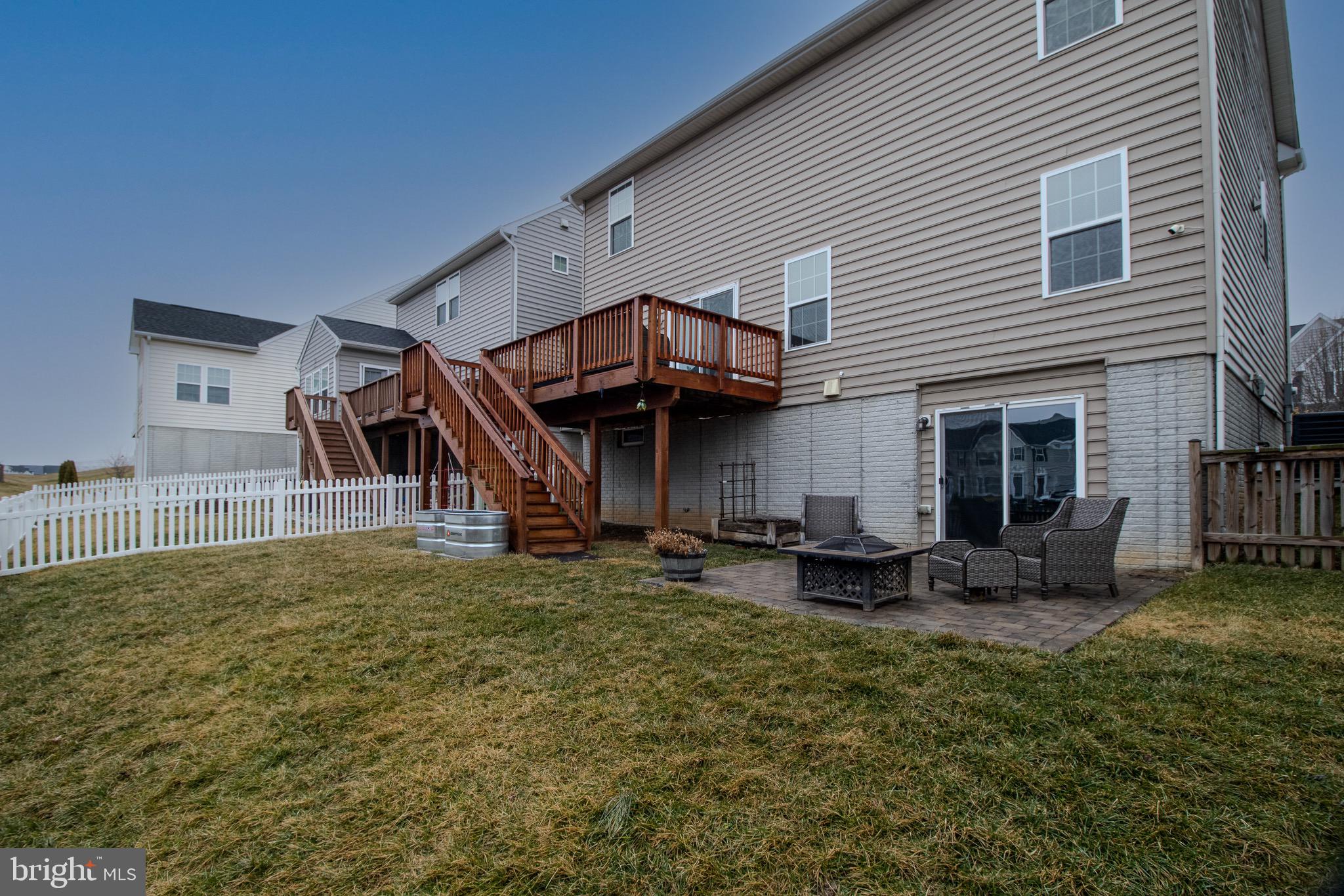 57 Tollerton Trail Falling Waters, WV 25419 - Photo 57 of 59 a view of a house with backyard and sitting area