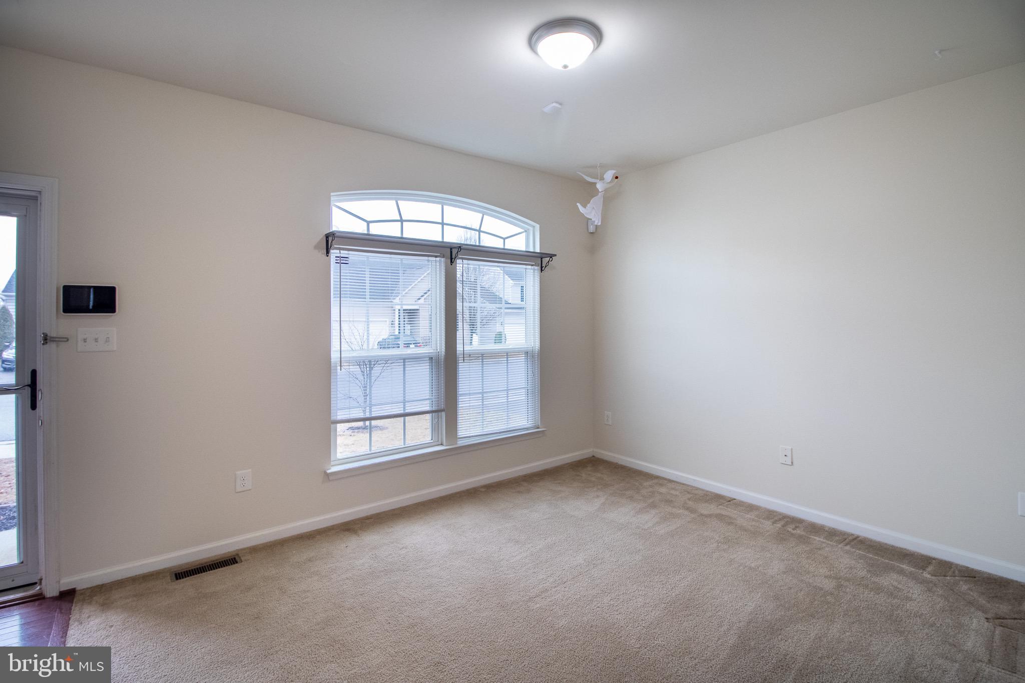 57 Tollerton Trail Falling Waters, WV 25419 - Photo 7 of 59 an empty room with wooden floor and windows