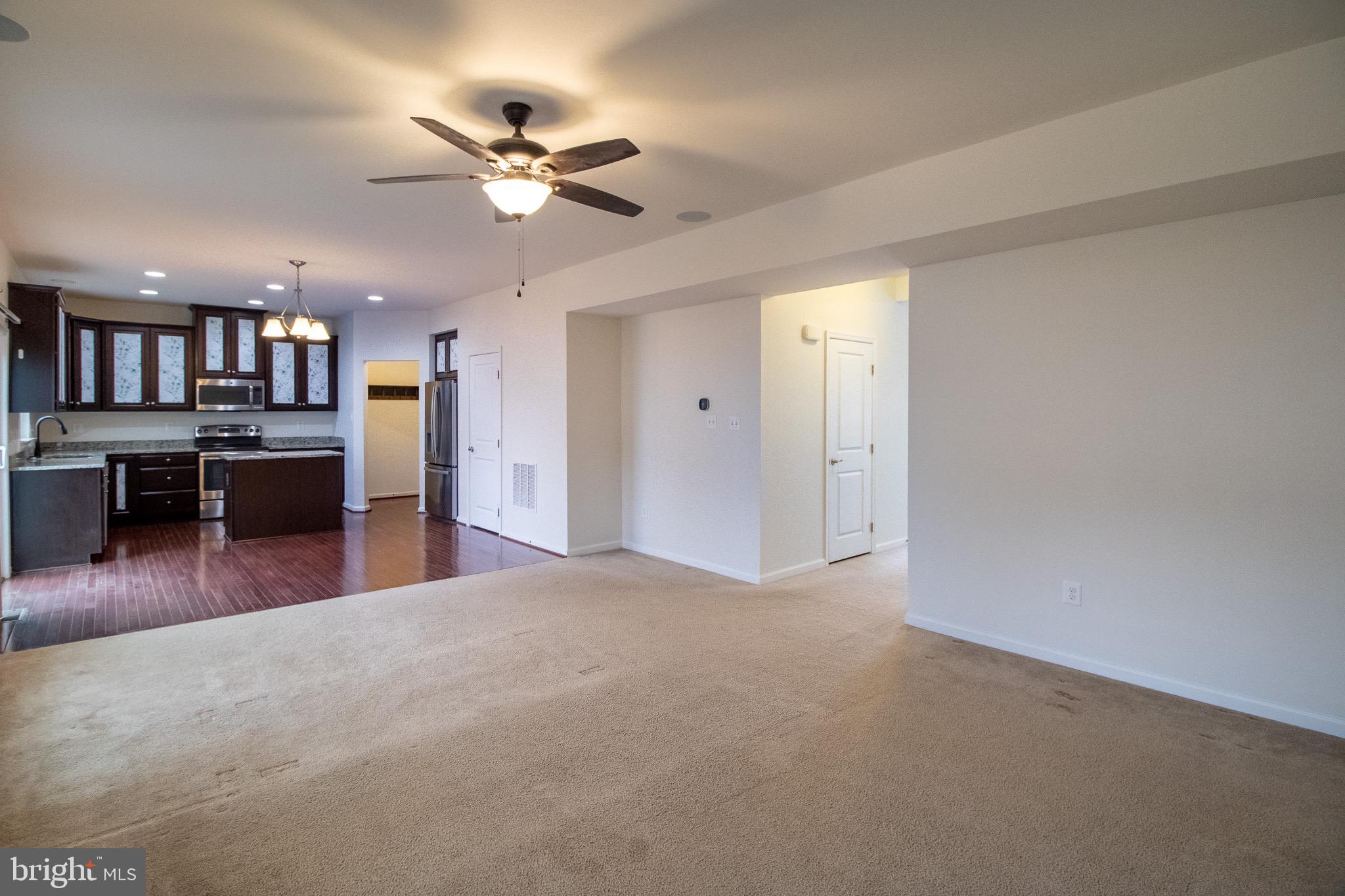 57 Tollerton Trail Falling Waters, WV 25419 - Photo 9 of 59 a view of a livingroom with furniture and a ceiling fan