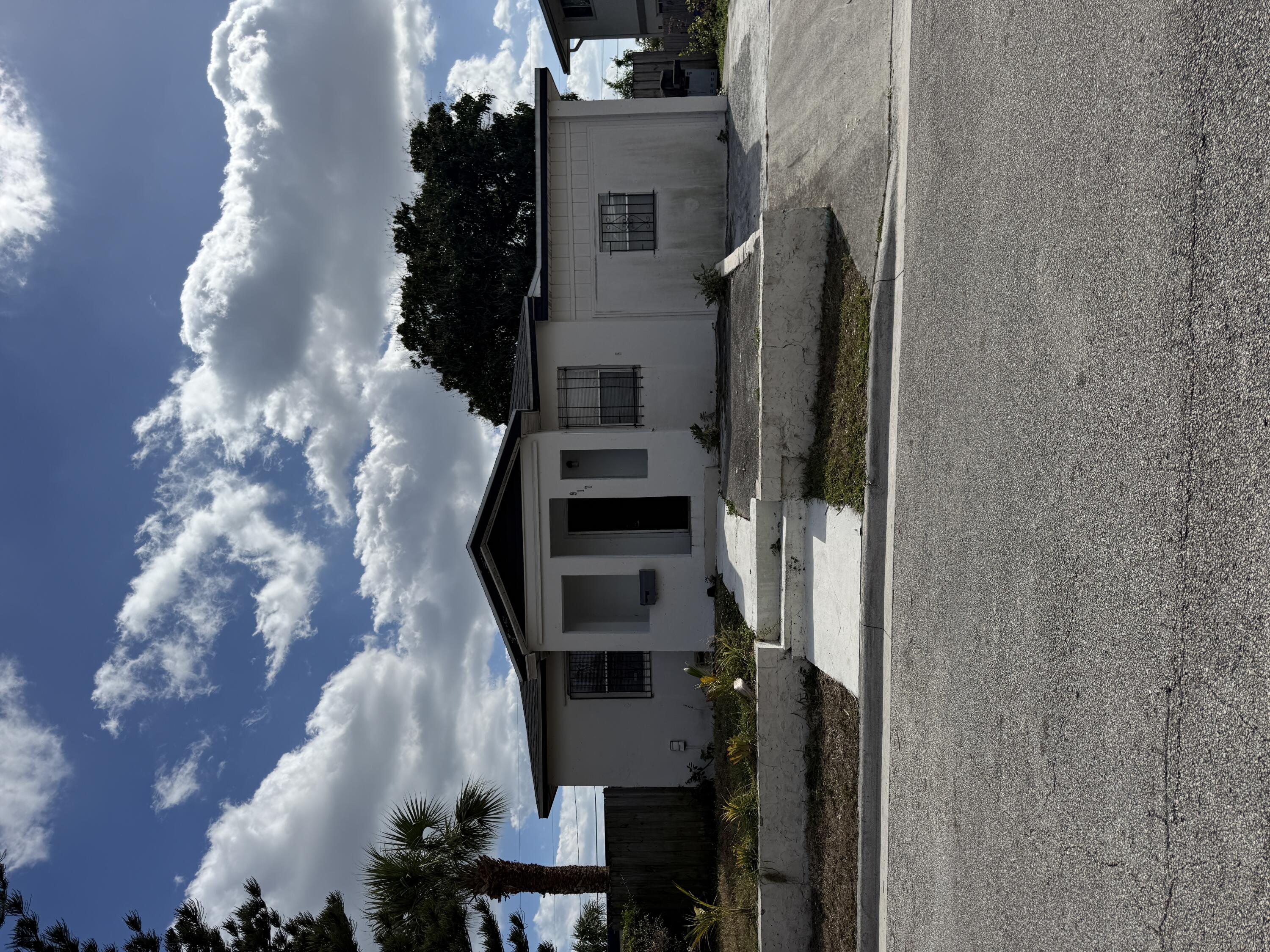 917 West 7th Street Riviera Beach, FL 33404 - Photo 1 of 1 a front view of a house with a yard