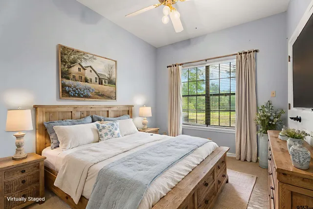 a bedroom with a bed and a large window