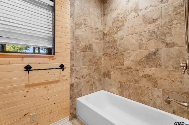 a bathroom with a bathtub and shower