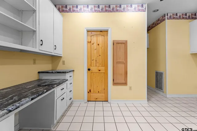 a kitchen with a refrigerator a stove and cabinets