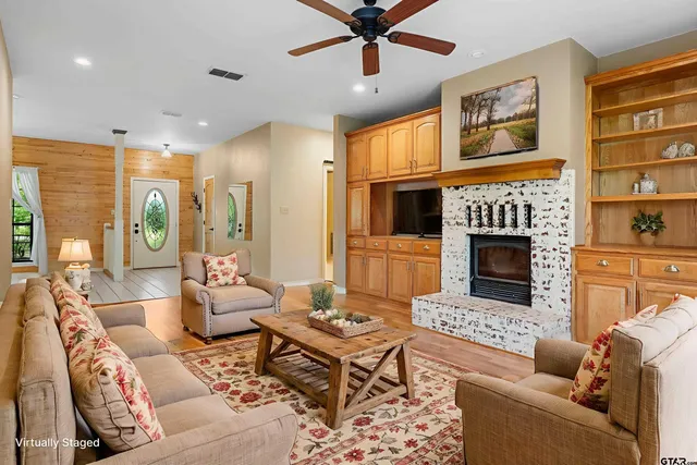 a living room with furniture fireplace and window