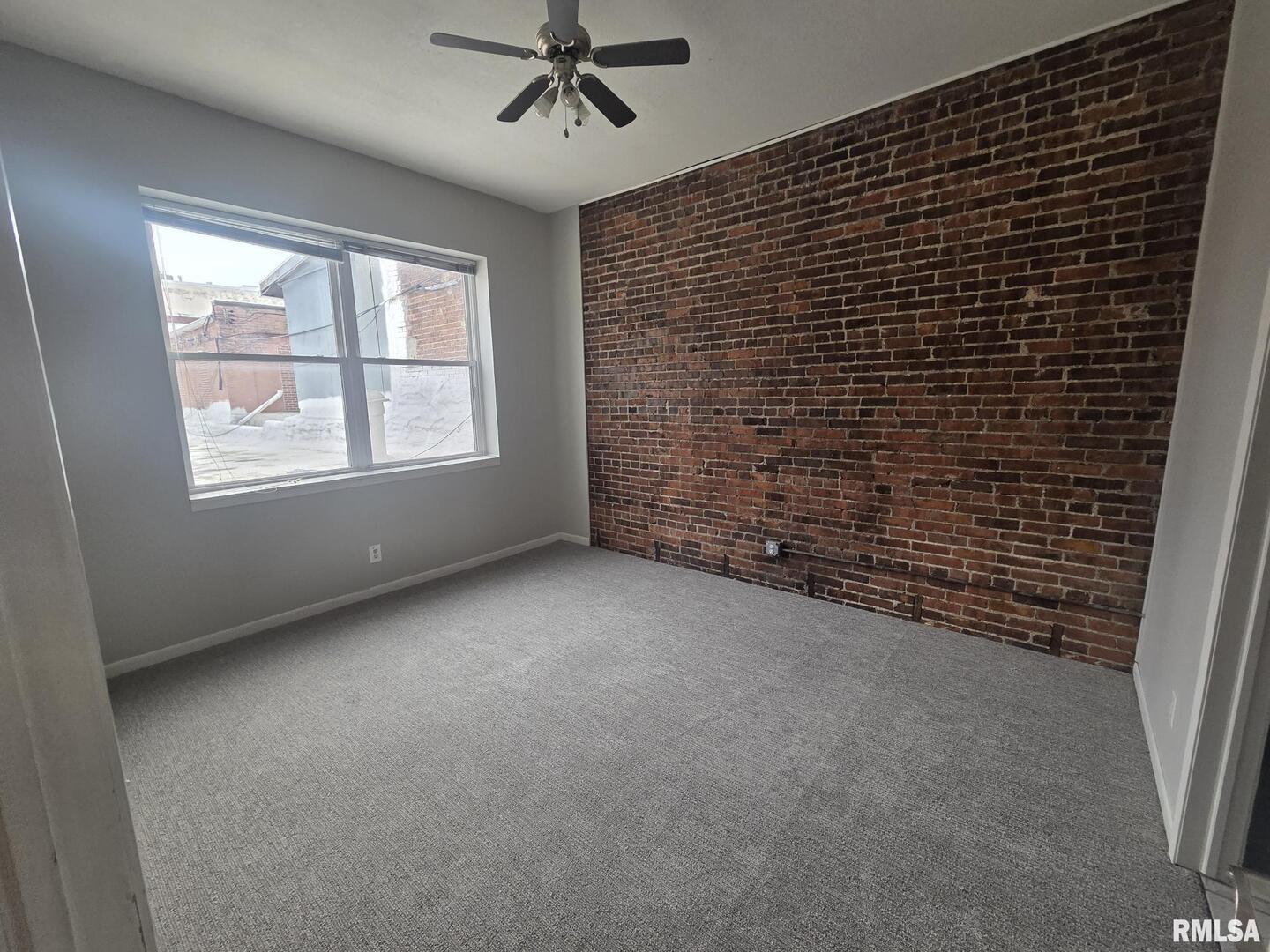 1706 2nd Street Rock Island, IL 61201 - Photo 2 of 9 a view of an empty room with a window