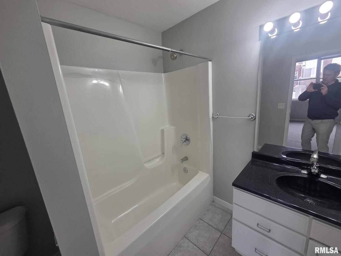 1706 2nd Street Rock Island, IL 61201 - Photo 4 of 9 a bathroom with a granite countertop sink a mirror and a bathtub