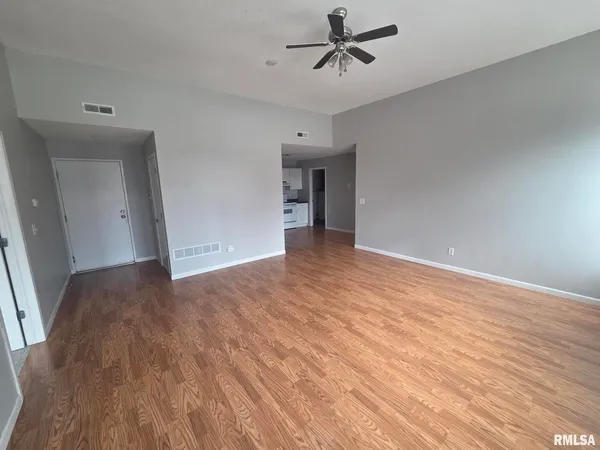 a kitchen with wooden floors and white appliances