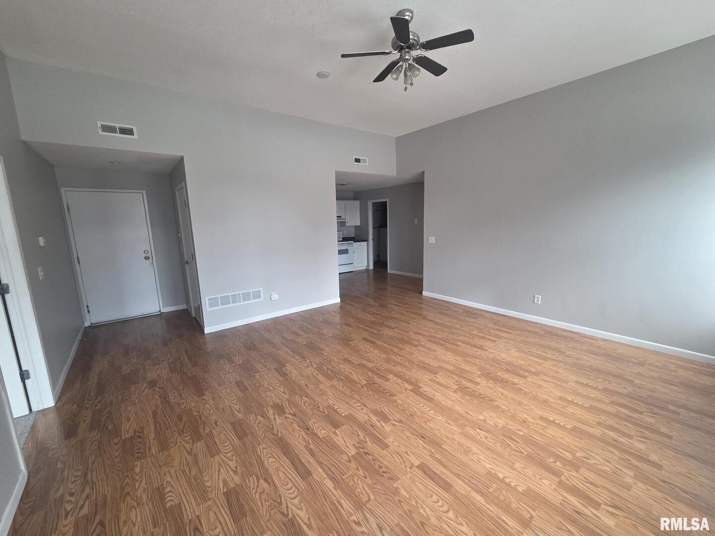 1706 2nd Street Rock Island, IL 61201 - Photo 5 of 9 a view of empty room with wooden floor and ceiling fan