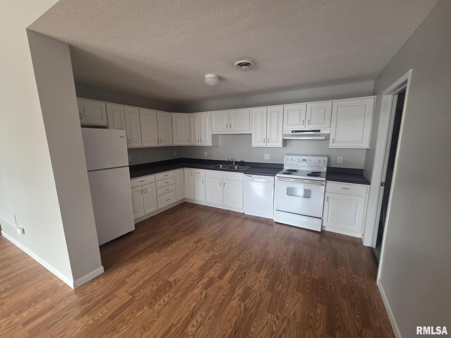 1706 2nd Street Rock Island, IL 61201 - Photo 6 of 9 a kitchen with wooden floors and white appliances