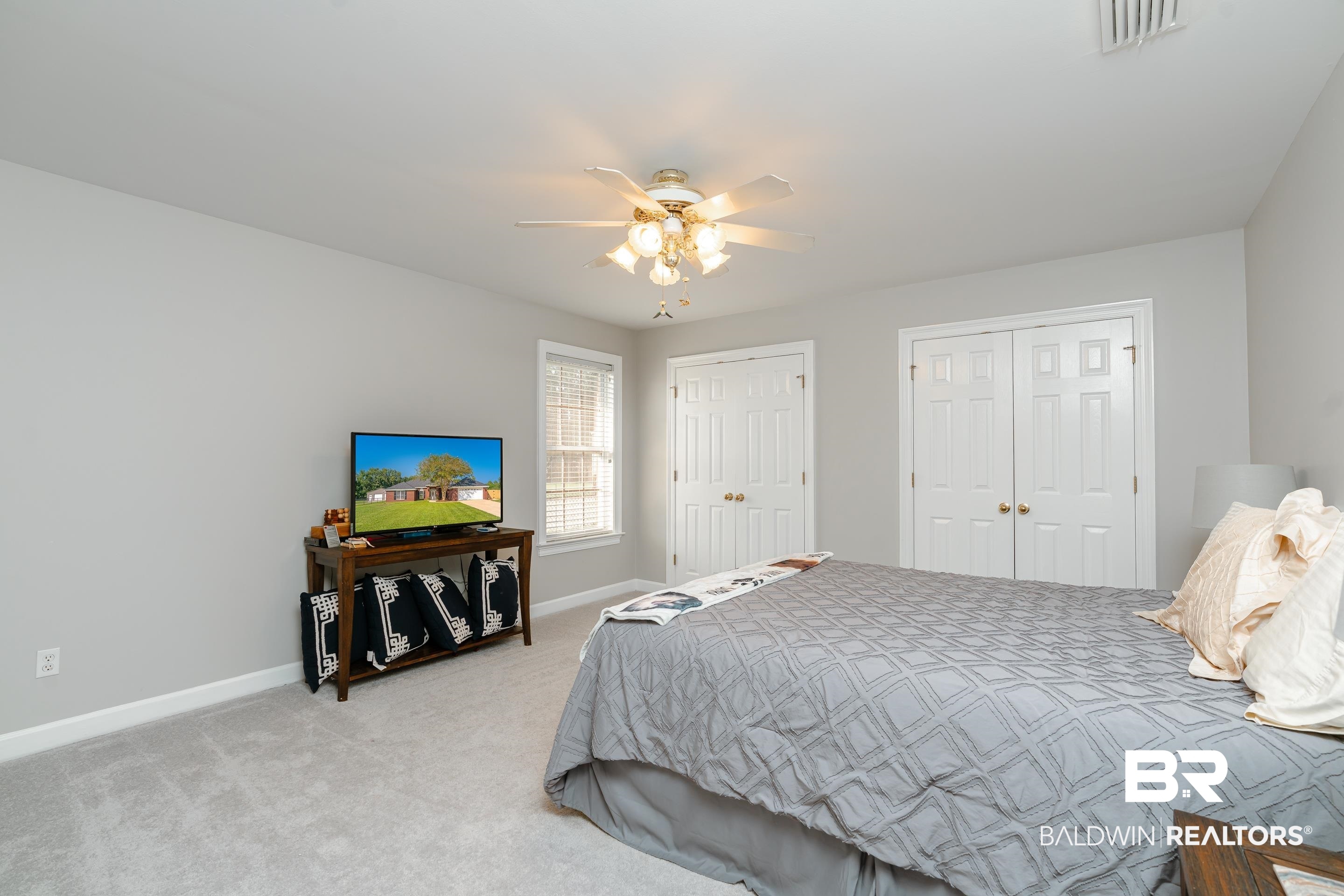 9477 Deerfield Drive Irvington, AL 36544 - Photo 29 of 58 Carpeted bedroom featuring ceiling fan and two closets