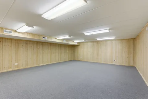 an empty room with a ceiling fan and window