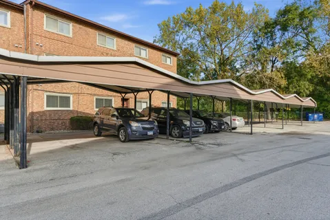 a view of a patio with table and chairs under an umbrella