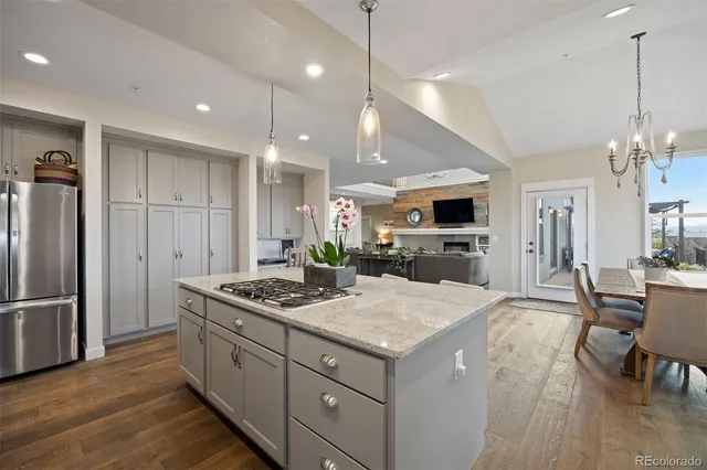a kitchen that has a lot of cabinets a sink and a refrigerator