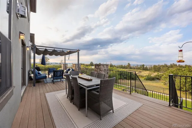a view of a balcony with chairs and wooden floor