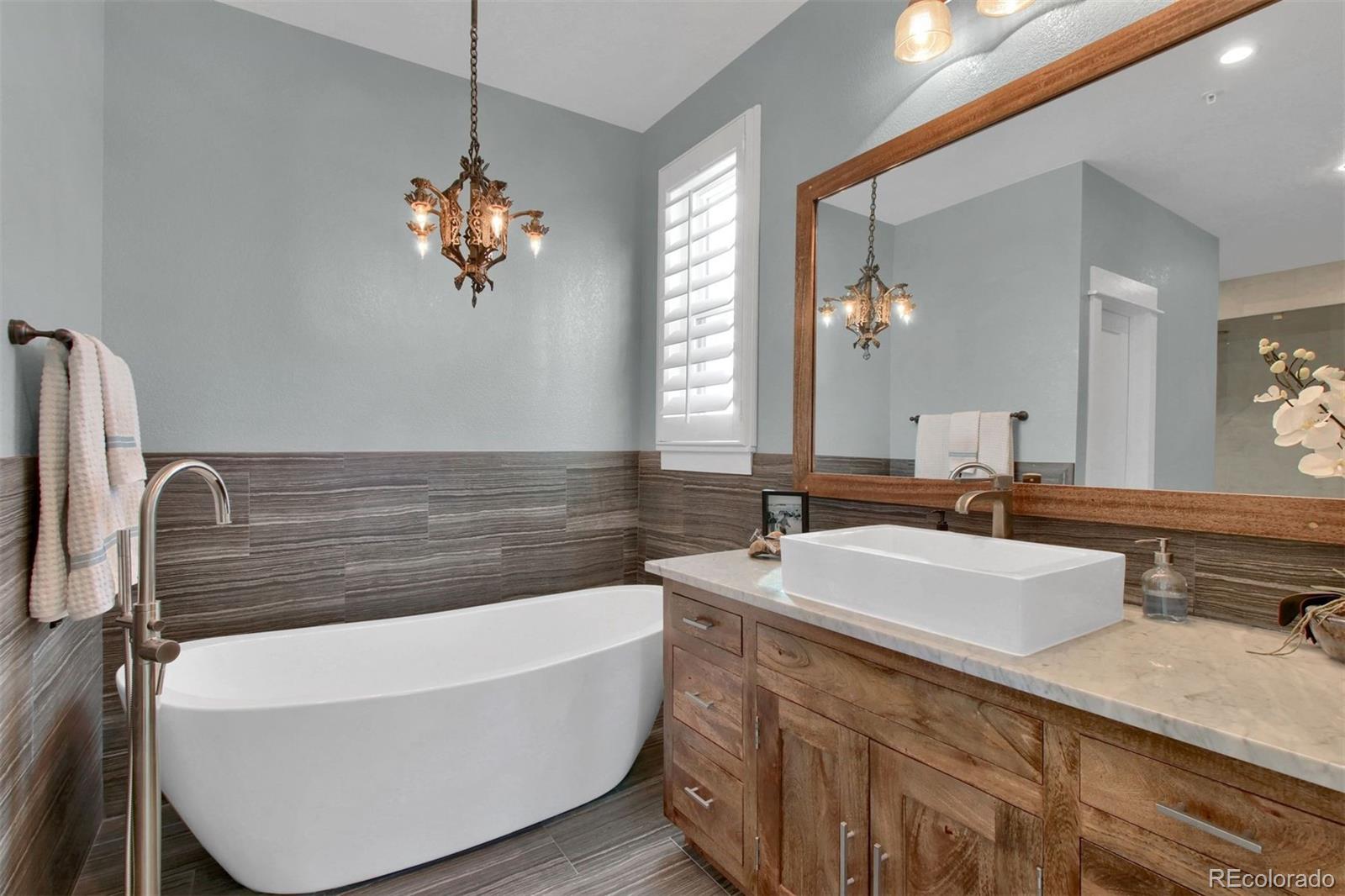 2940 Canon Ridge Road Castle Rock, CO 80104 - Photo 24 of 49 a bathroom with a tub double vanity and a mirror