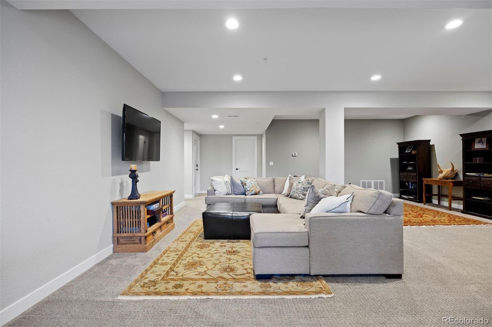 2940 Canon Ridge Road Castle Rock, CO 80104 - Photo 30 of 49 a living room with furniture and a flat screen tv