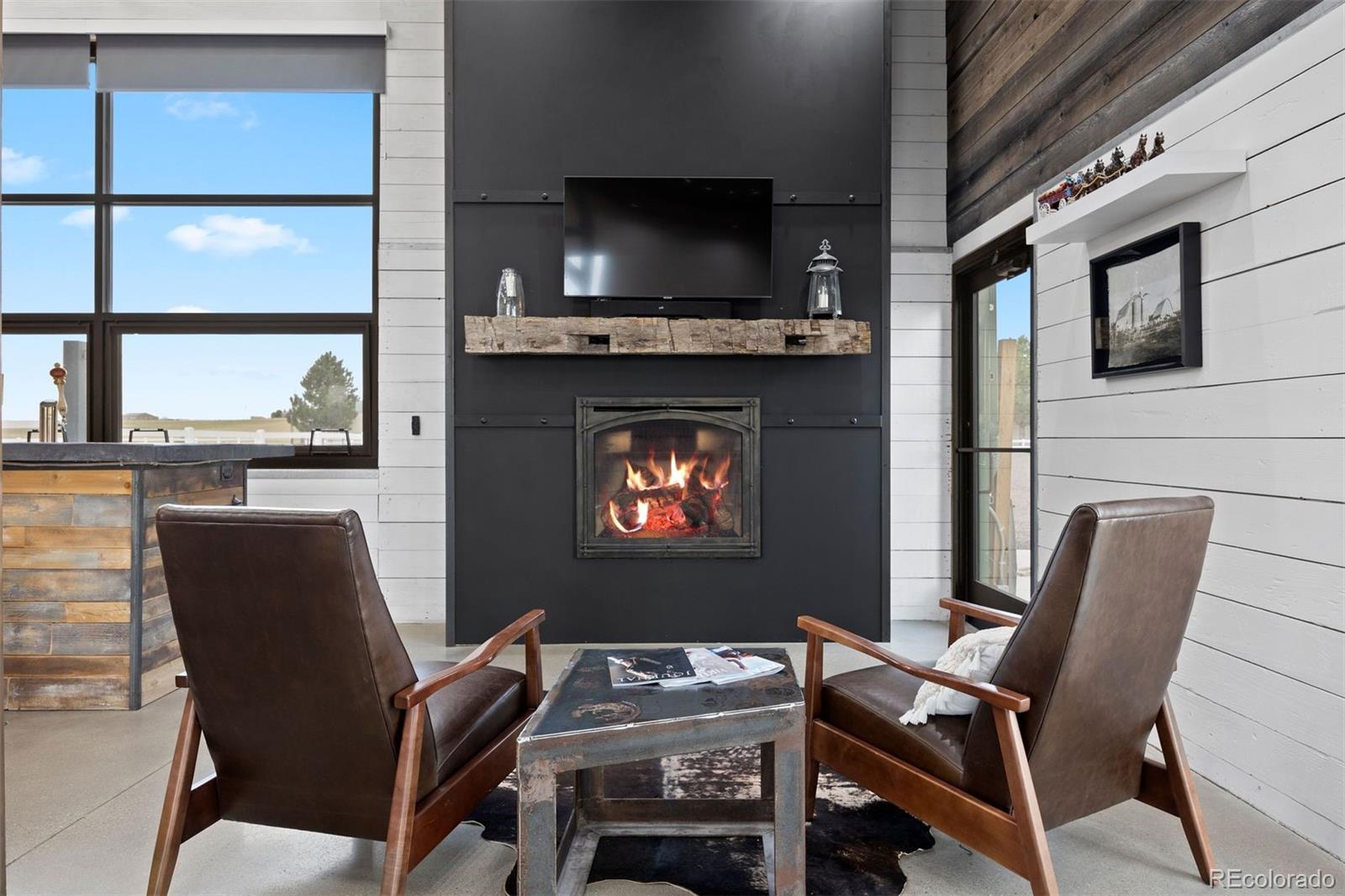 2940 Canon Ridge Road Castle Rock, CO 80104 - Photo 37 of 49 a living room with furniture a flat screen tv and a fireplace