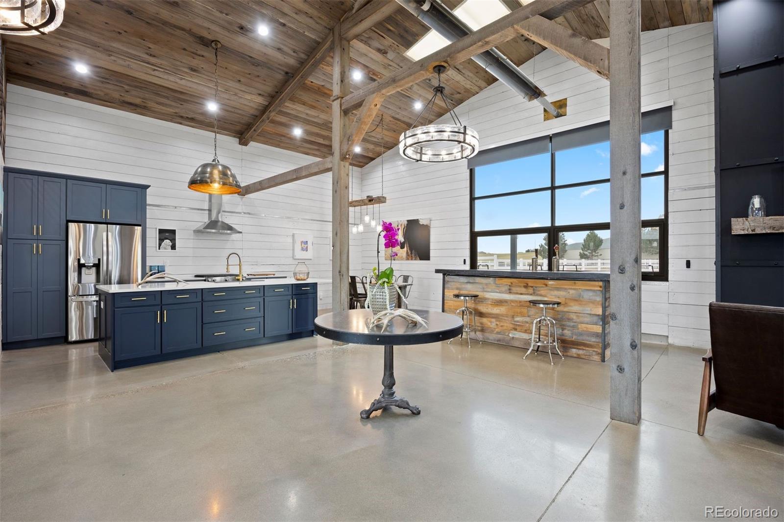 2940 Canon Ridge Road Castle Rock, CO 80104 - Photo 38 of 49 a room with stainless steel appliances kitchen island granite countertop furniture and a kitchen view